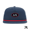 A navy blue performance snapback hat featuring a red rope detail and a central navy oval patch with a red embroidered border.